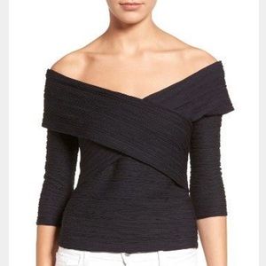 Black fitted off-shoulder top.